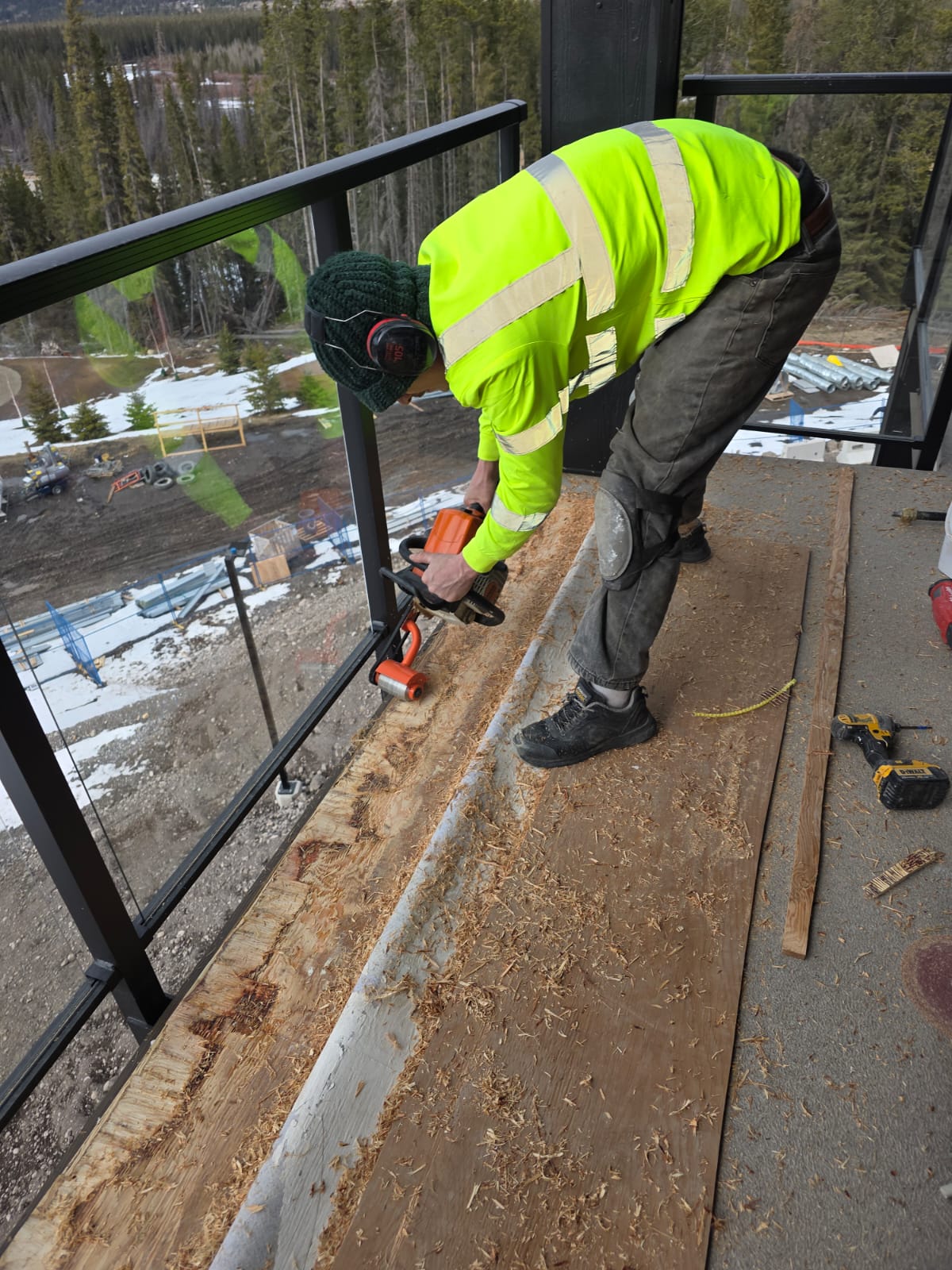 Crew member preparing a deck surface for vinyl membrane installation